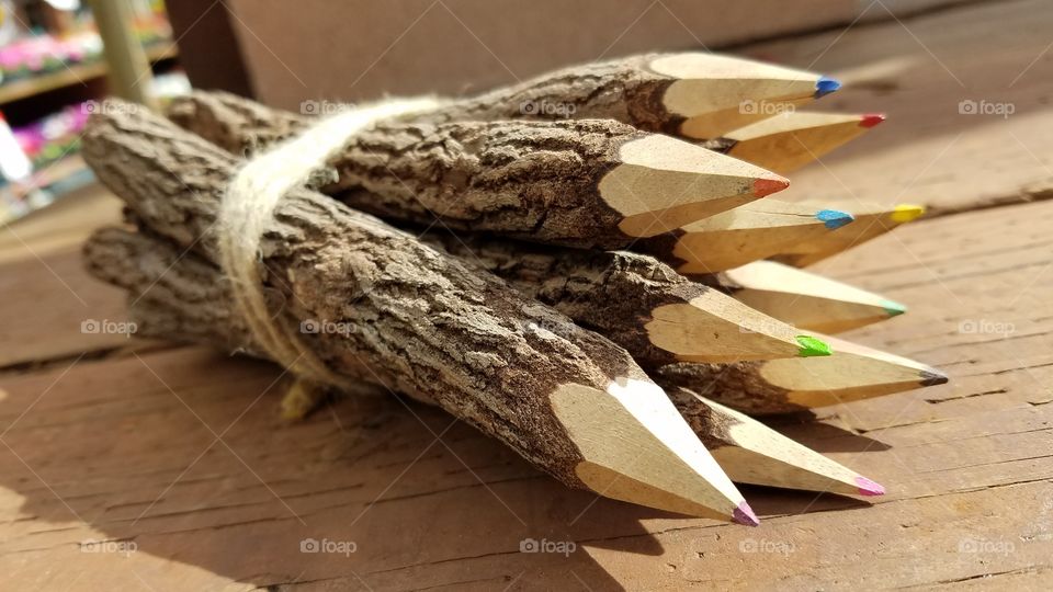 Multi-colored pencils tied up with rope