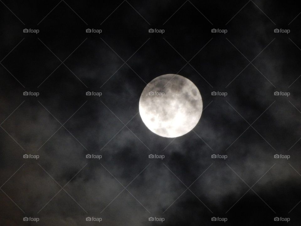 Clouds passing full moon
