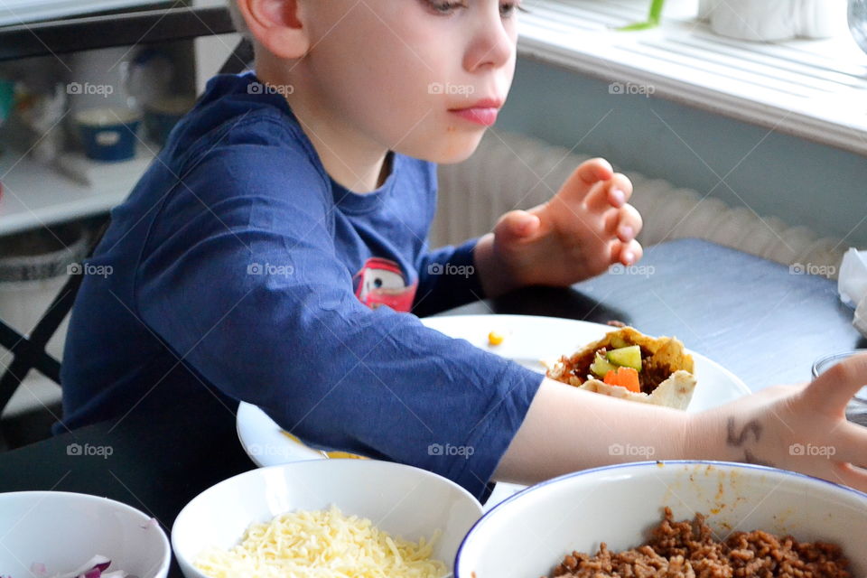 Boy eating tacos