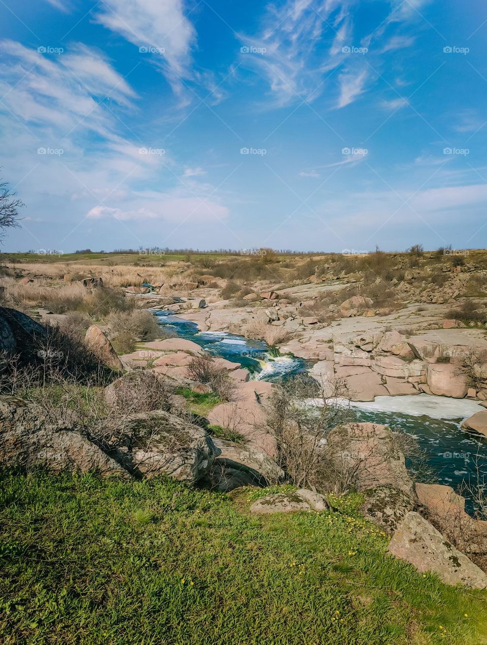 Blue river with waterfalls among granite rocks