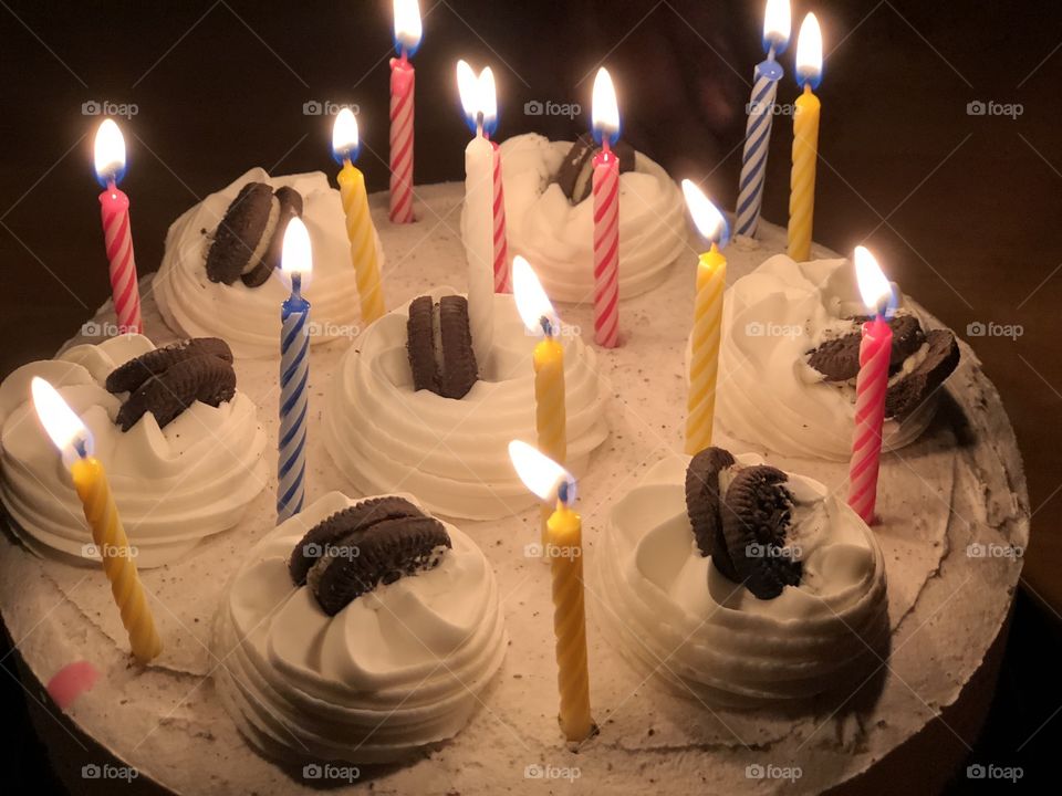 An Oreo birthday cake with lit candles
