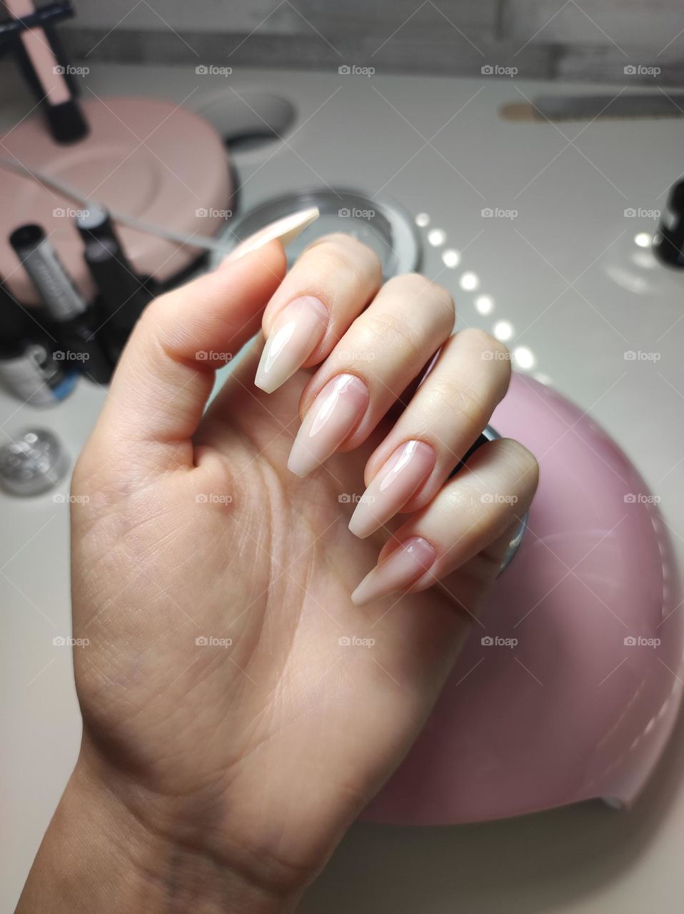 Doing a manicure /Manicurist /Manicure at home/Self made beauty salon/ Beauty places and products / Manicure base, accessories and gels/ Manicure gadgets/ Manicured hand with long nails