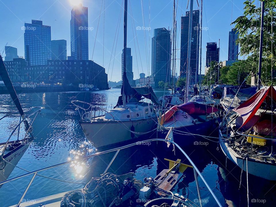 This is amazing “Newtown Creek” by the “Pulaski Bridge” in LIC, Queens with its variety of boats and fantastic sights that easily reach all the way to “Manhattan” on a clear day such as this is. 2023. Hypnotic Productions