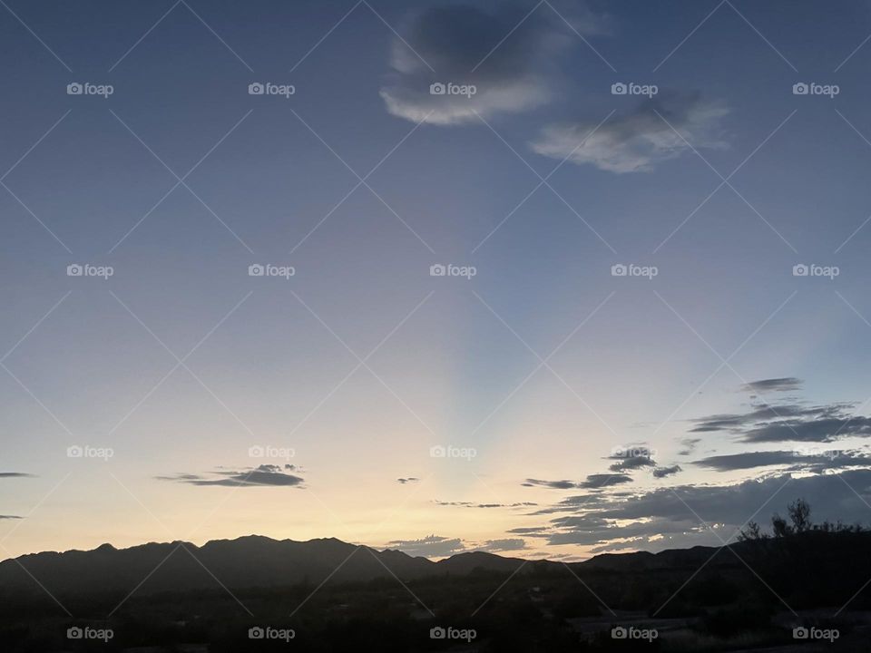 A colorful mountain sunset with clouds. 