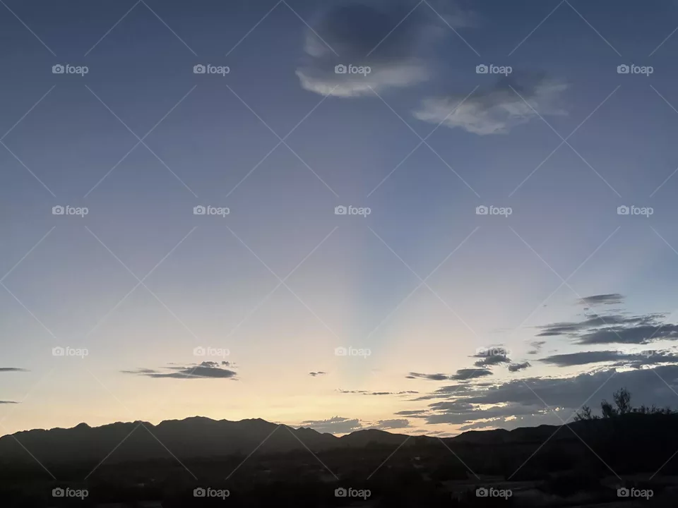 A colorful mountain sunset with clouds. 