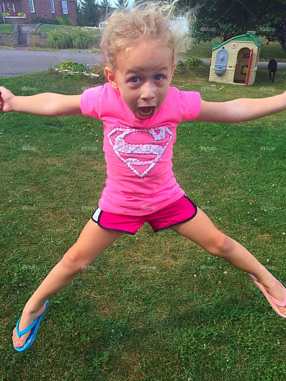 Girl jumping on lawn