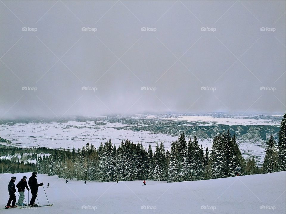 People skiing on snowy slope