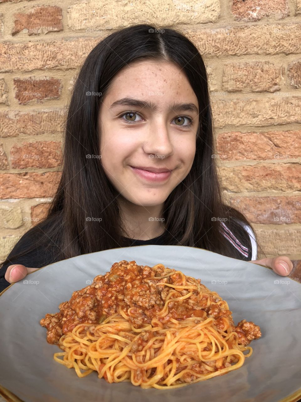 Young girl showing her noodles dish