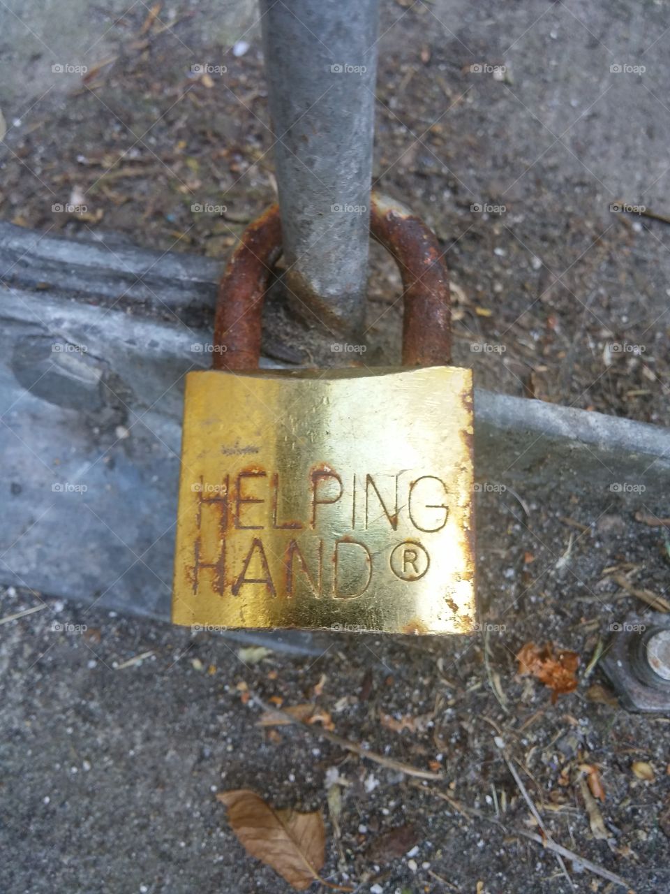 Helping Hand. on break at work, looked down at the bike rack and saw this rustic lock