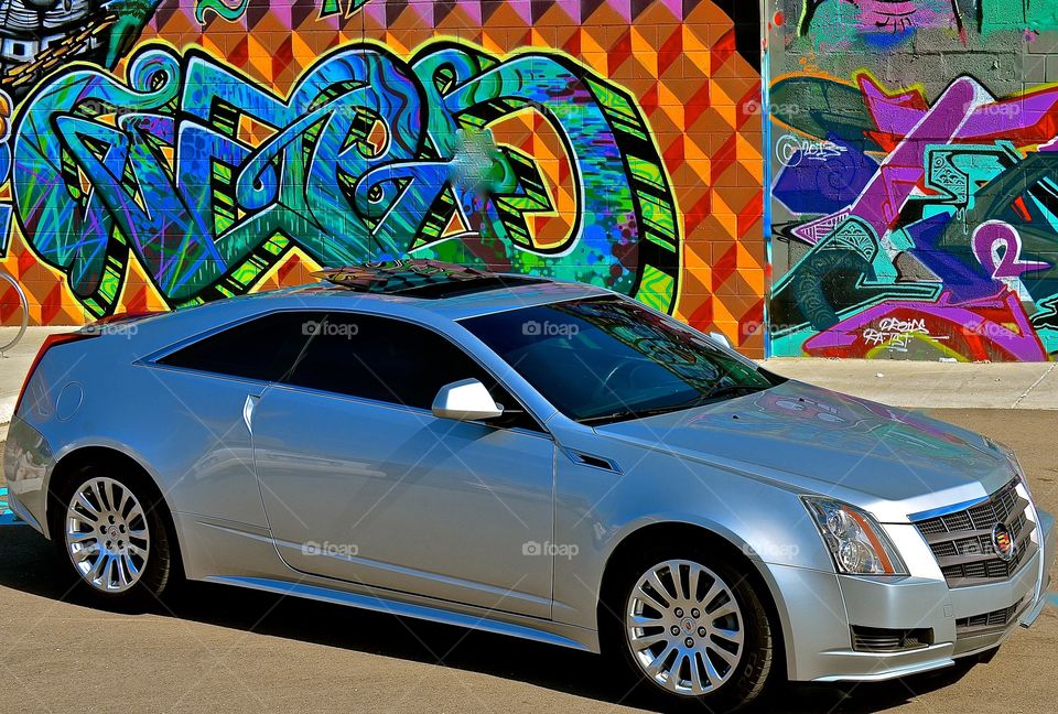 Graffiti caddy. Car on graffiti wall