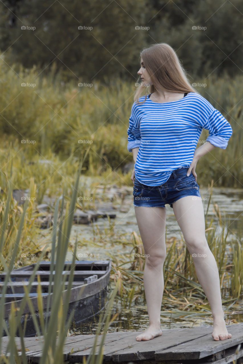 A girl with blond hair on the lake in a striped shirt and short denim shorts on the background of grass, reeds and an old wooden boat
Girl, woman, man, blonde, blonde hair, striped shirt, short shorts, denim shorts, shore, lake, grass, reeds, old boat, feelings, emotions, tenderness, love, lifestyle, lifestyle, vacation