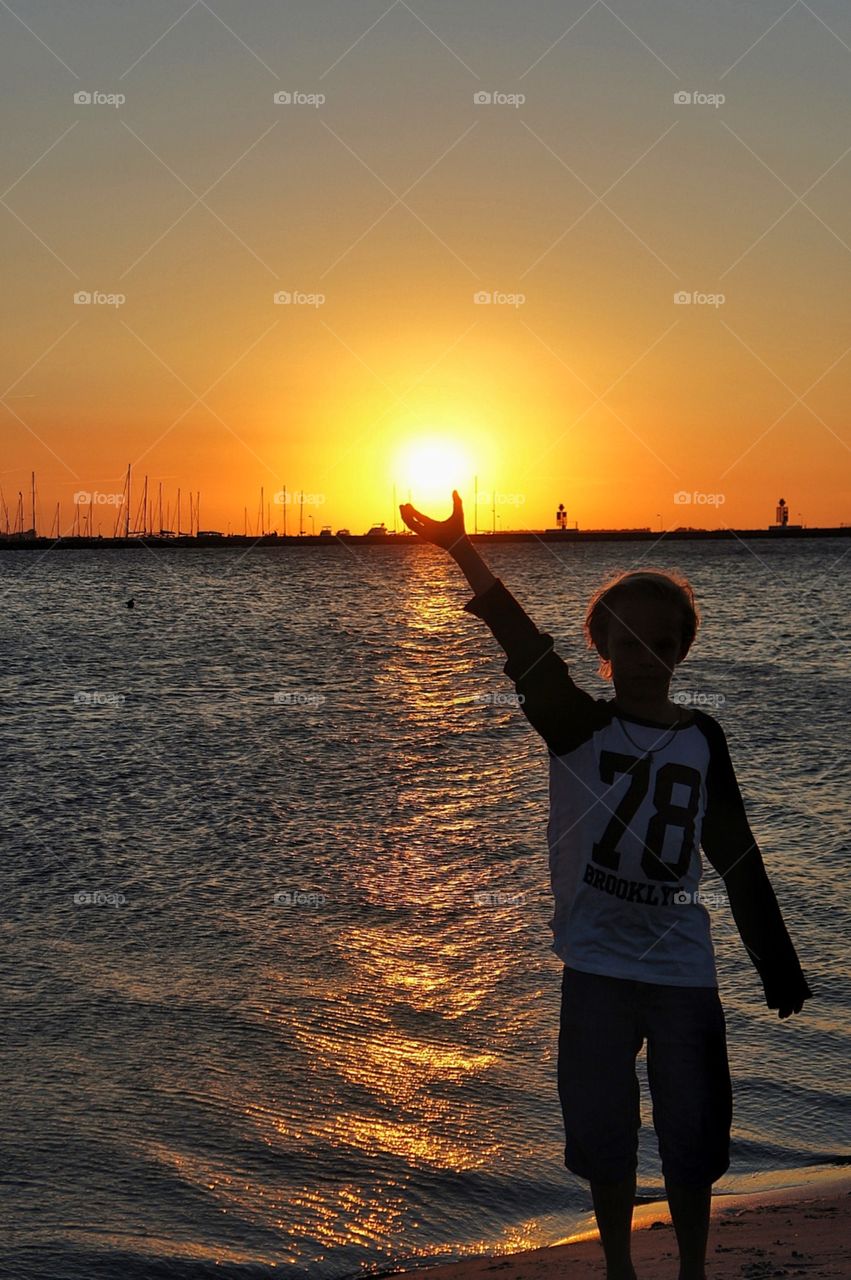 Holding the sun in his hand