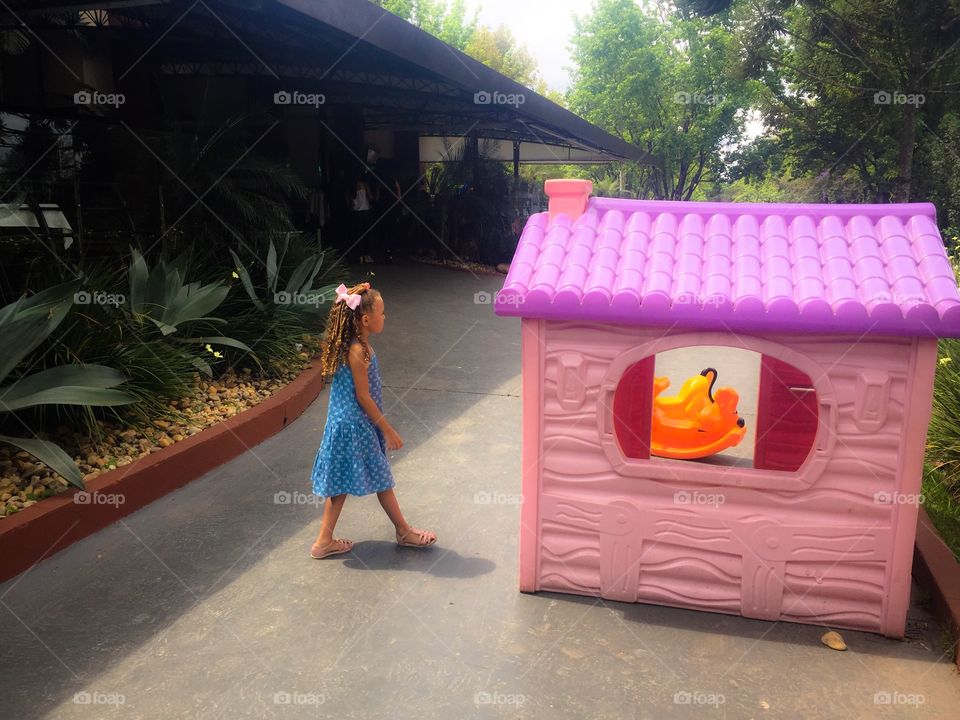 Girl and little pink house