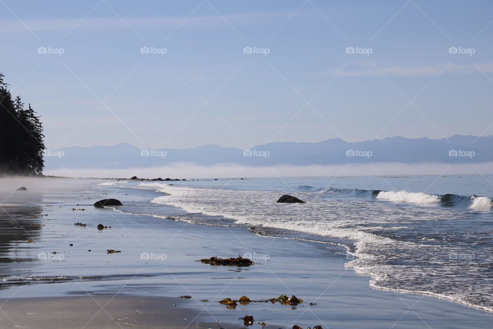 Blue sea. With waves crashing on the shore during low tide on summertime 