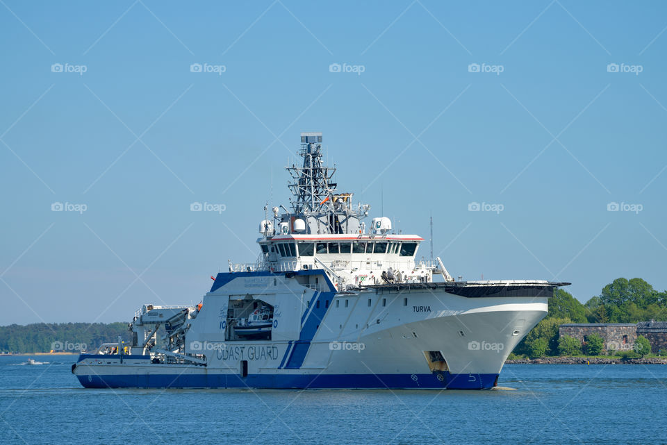 Helsinki, Finland - June 9, 2017:  Finnish Border Guard offshore patrol vessel Turva on sunny summer evening in front of Suomenlinna Fortress Island in Helsinki, FInland. Turva is the largest vessel of the fleet and coducts the search and rescue missions in the Baltic Sea. Vessel is powered by liquefied natural gas (LNG)
