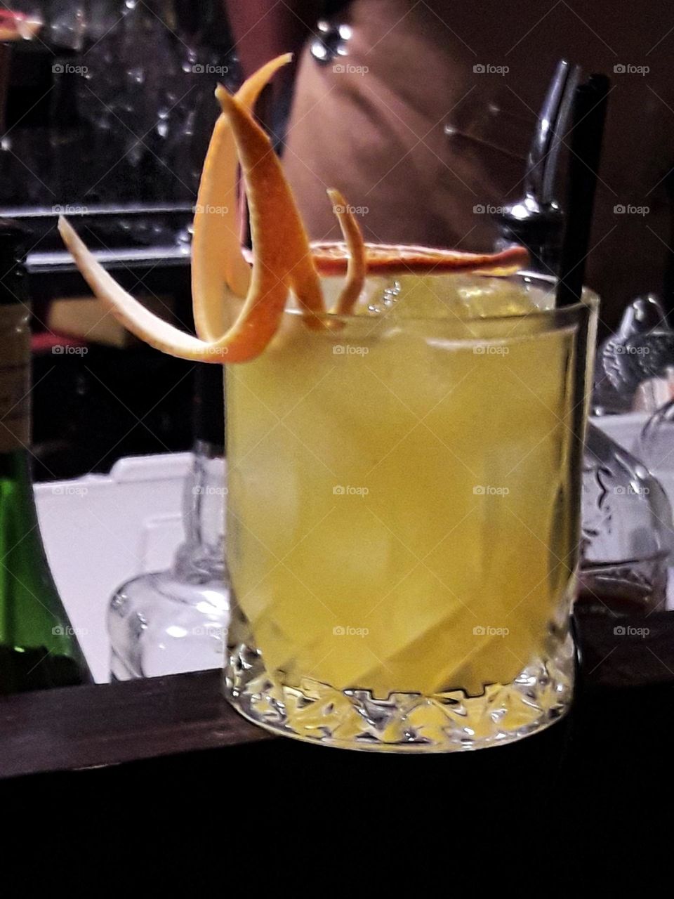 Yellow cocktail with orange slices