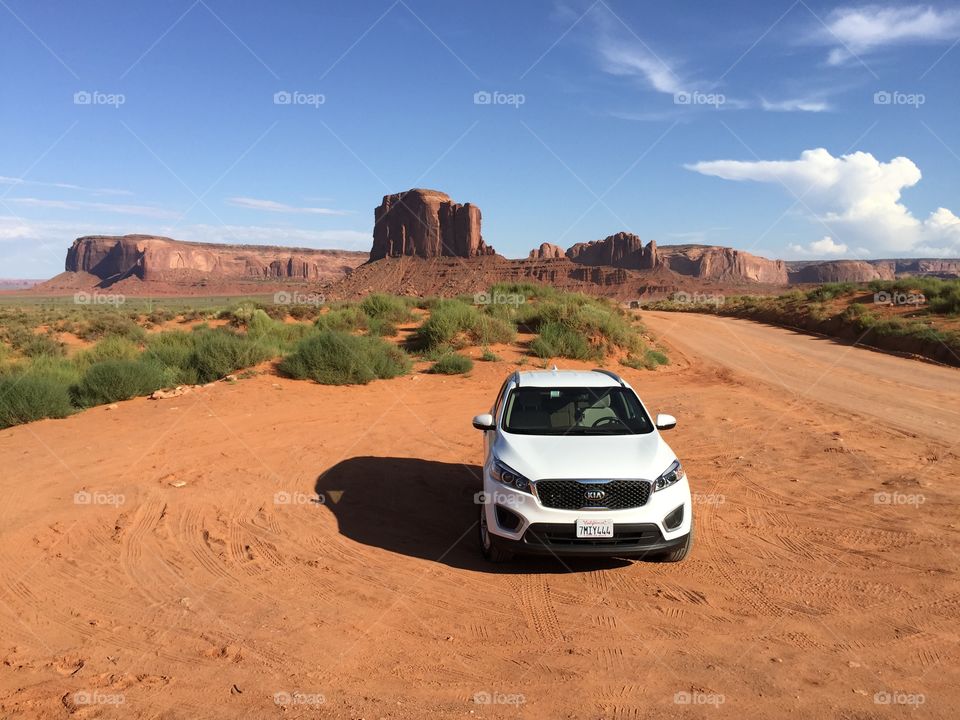 Car is standing in the middle of the monument valley tribal park