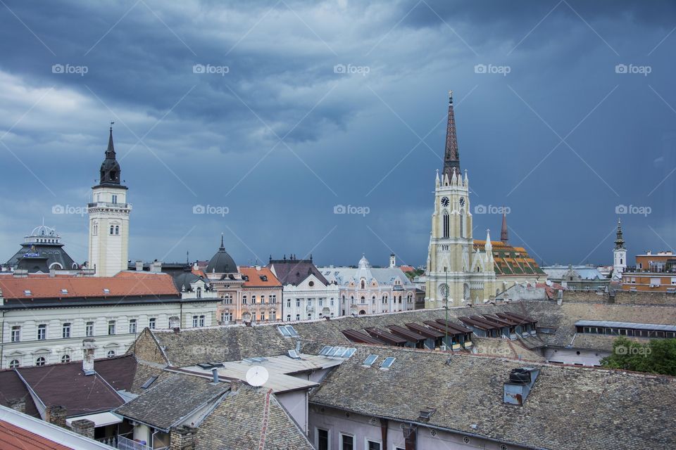 roofs in city center before the storm. roofs and church tower in city center of Novi Sad