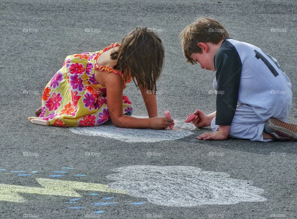 Boy And Girl Drawing With Chalk