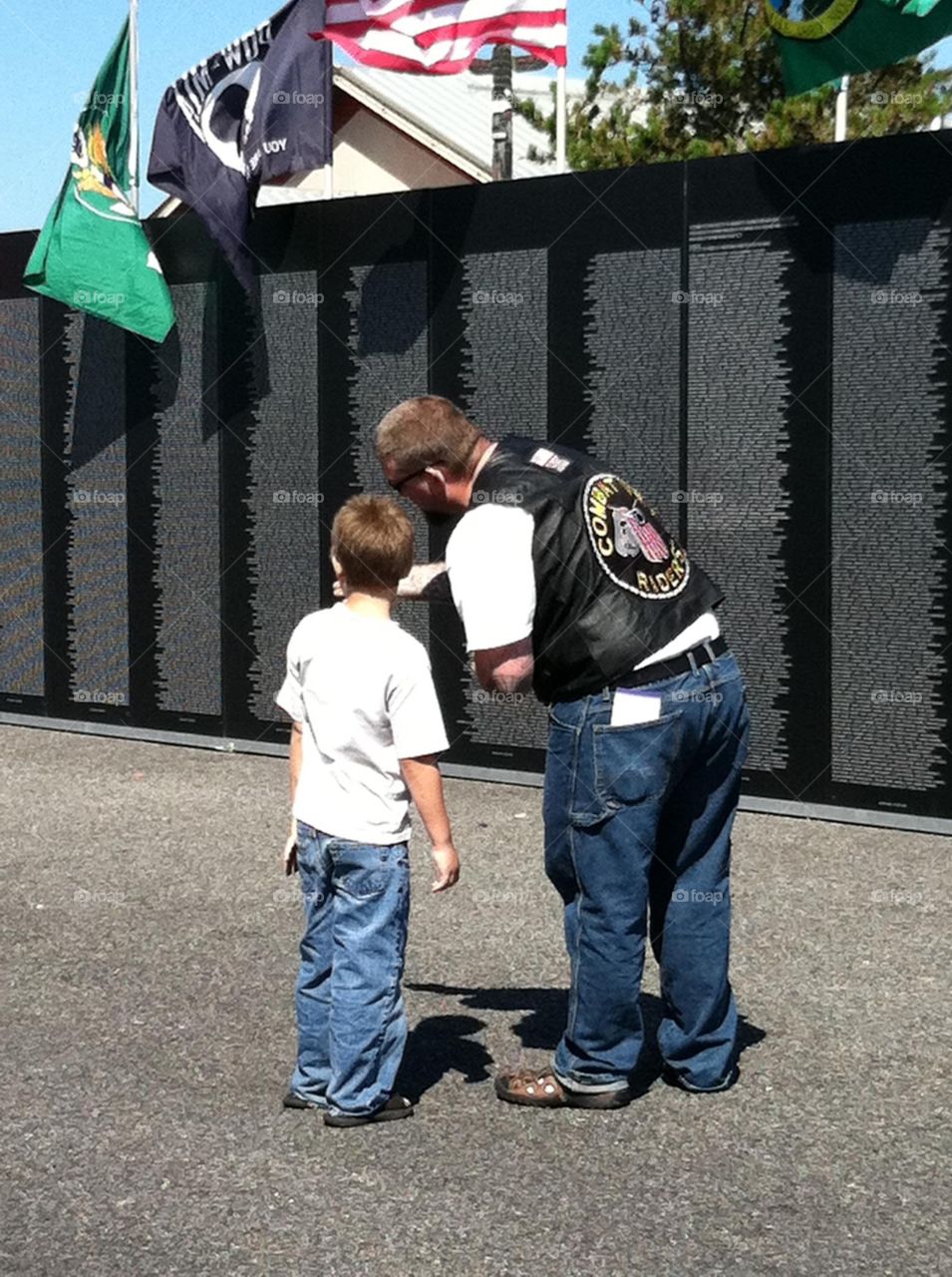 Vietnam War Traveling Memorial Wall. A father explains it to his son. 