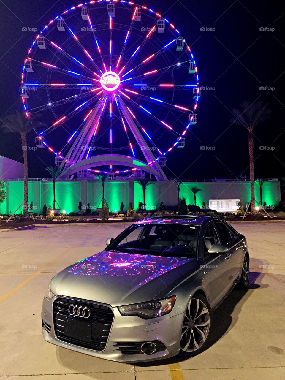 Cars with soul - 2014 Audi A6 4dr Sdn quattro 3.0L TDI Premium Plus with a reflection from a colorful Ferris Wheel 