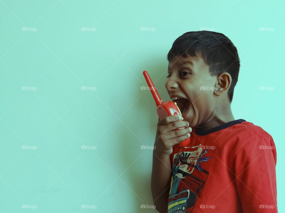 Boy playing with walkie talkie
