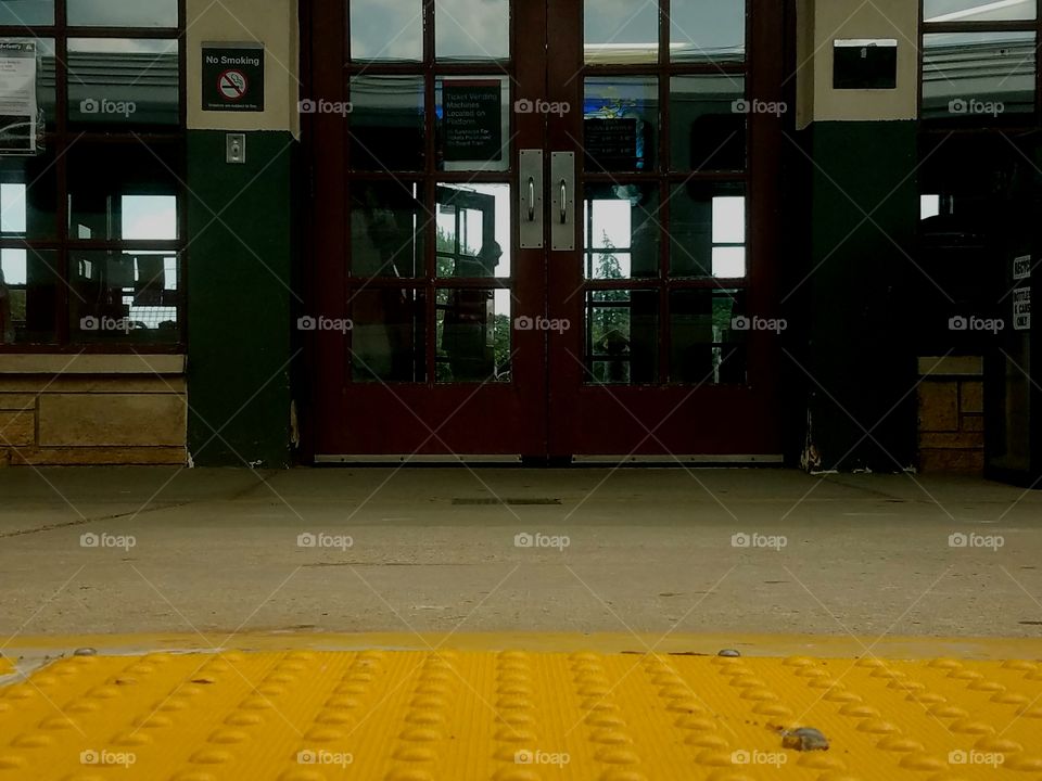 A view from below, as a commuter train pulls into a stop.
