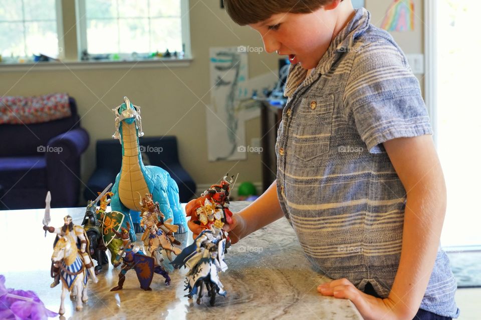 Boy Arranging His Toy Collection
