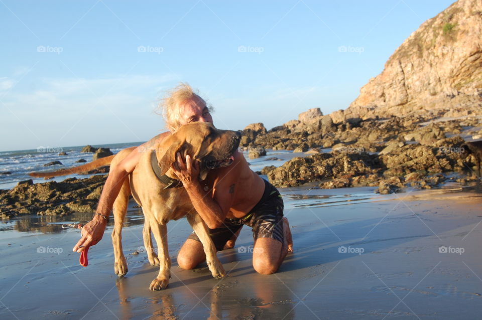 Man and dog hugging 