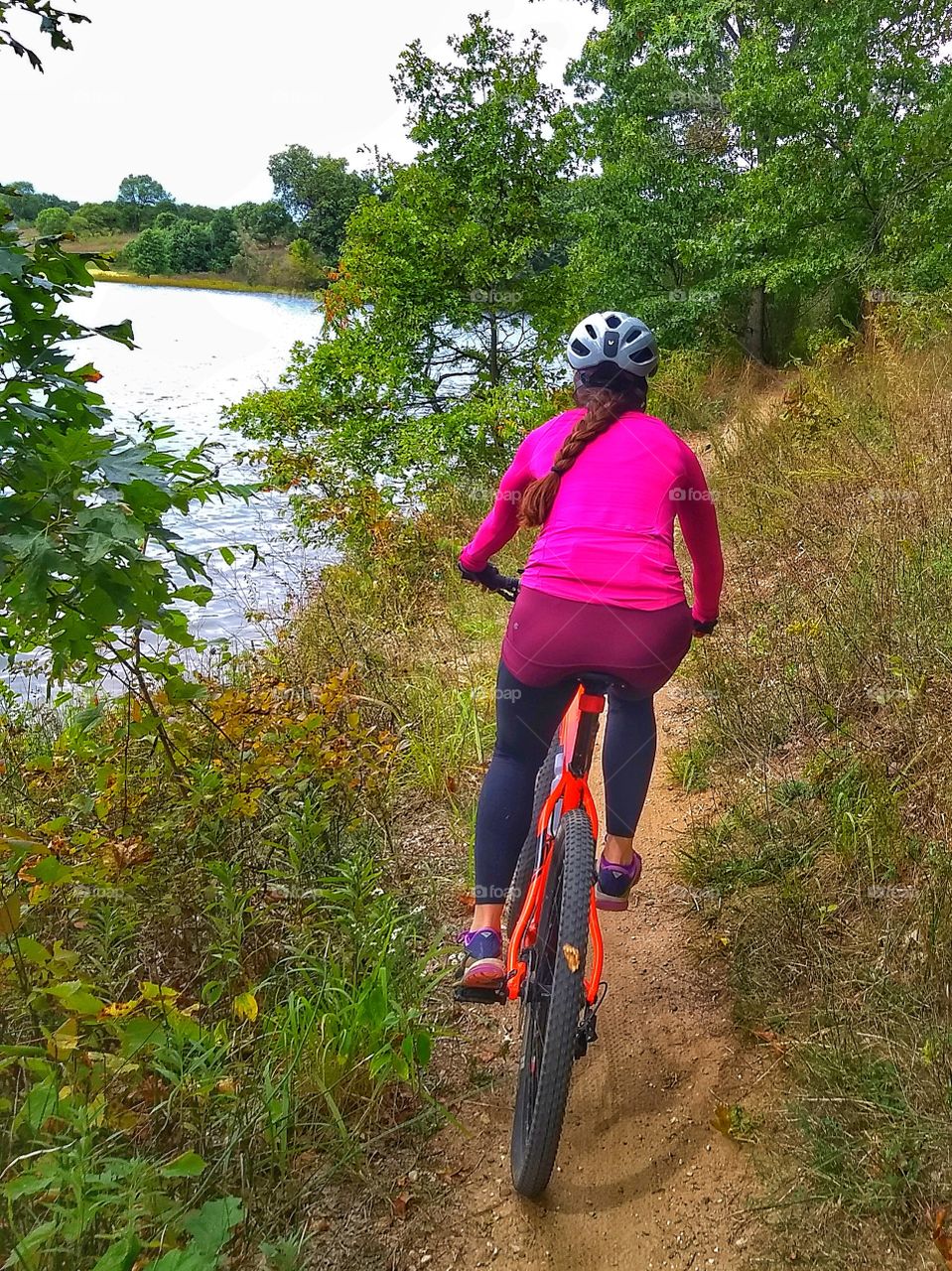 lady cyclist by lake