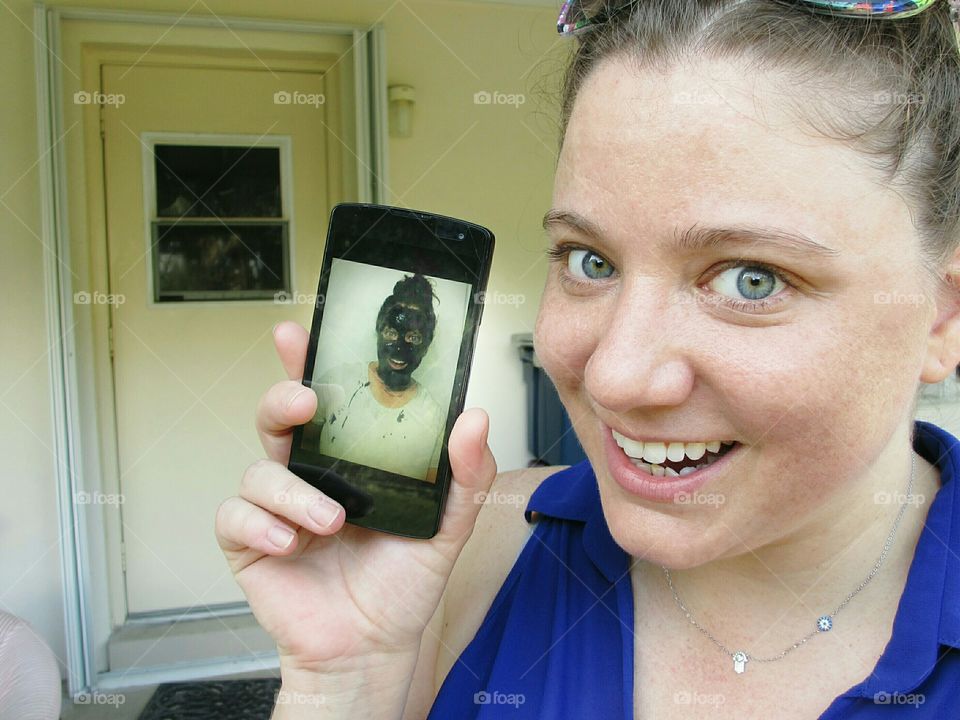 Close-up of a woman holding mobile phone in hand