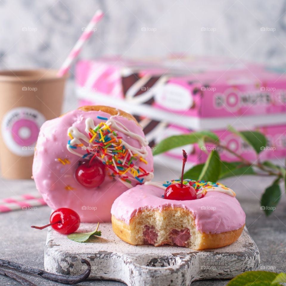 donut with pink icing and cherry