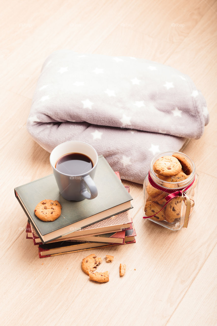 A few books with cup of coffee and cookies on wooden floor. Time for relax. Spending leisure time on reading. Cozy and comfortable. Relaxing π