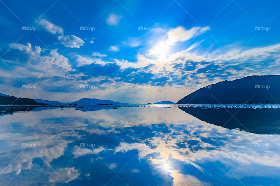 Reflection of clouds and mountain on lake