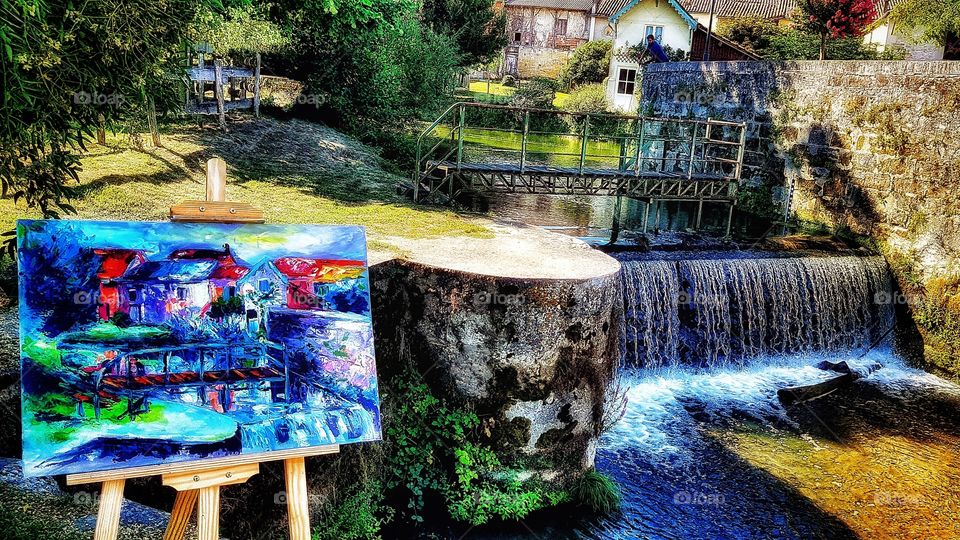 Painting by the weir - River Dropt, Allemans-du-Dropt, France. This is looking across the river to back of my two properties, the artist has painted the back of my house and back garden!! Unique.