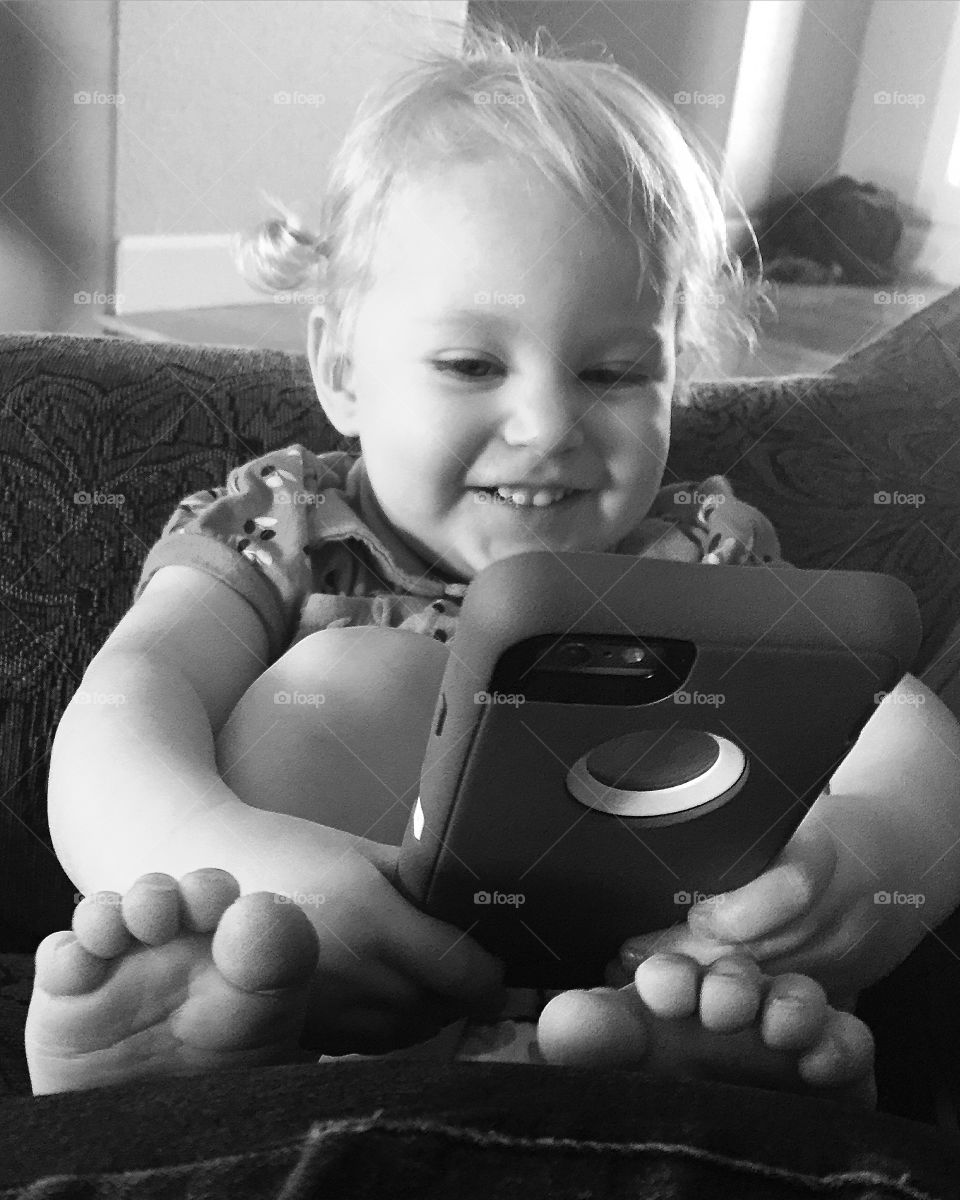 Toddler playing with iPhone