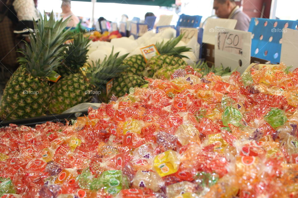 Yummy colorful candy and fruit at the bustling China town street market in the steep hills of San Francisco