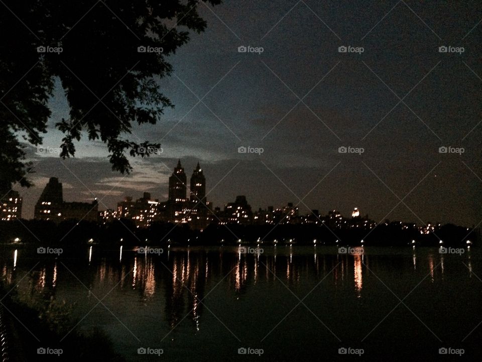 Upper West Side at Night. Reflections of the Upper  West Side skyline on the Central Park Reservoir at night