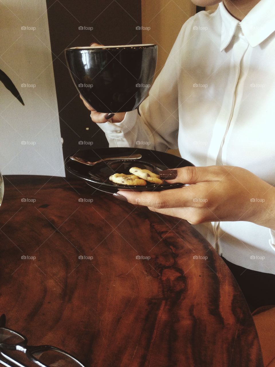 Woman drinking coffee and cookie