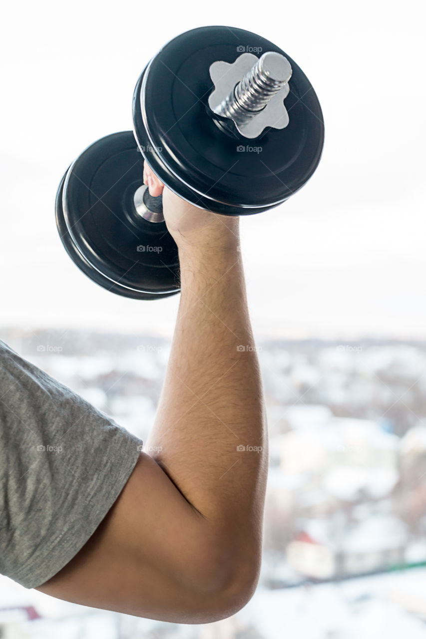 man with dumbbells doing exercises