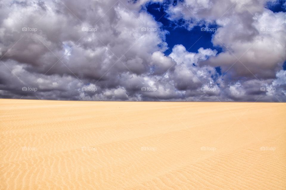 beautiful corralejo dunes on fuerteventura canary island in spain - cliydy sky and sandy dunes