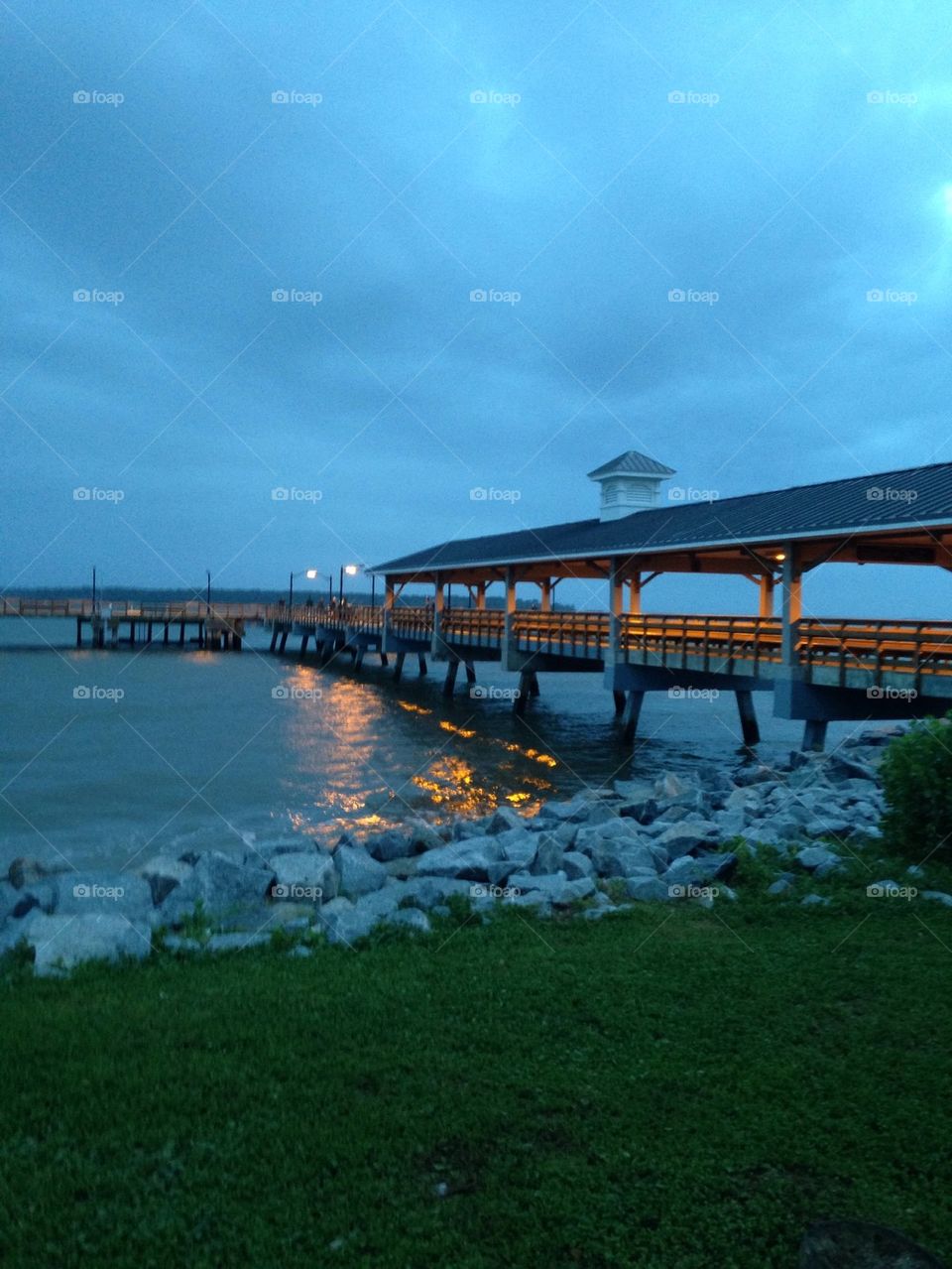 Pier on ocean at dusk