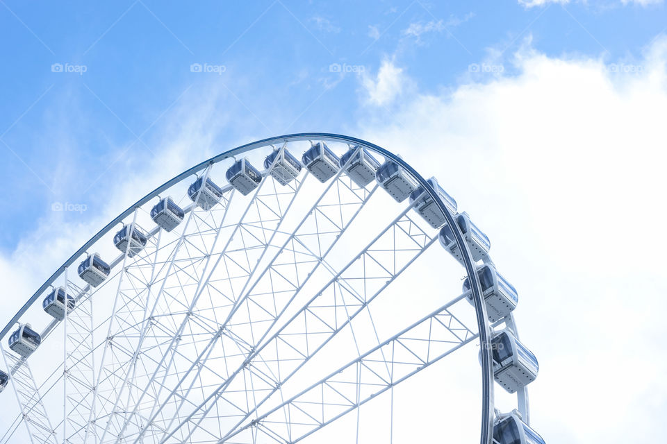 Ferris wheel against the bright blue sky. 