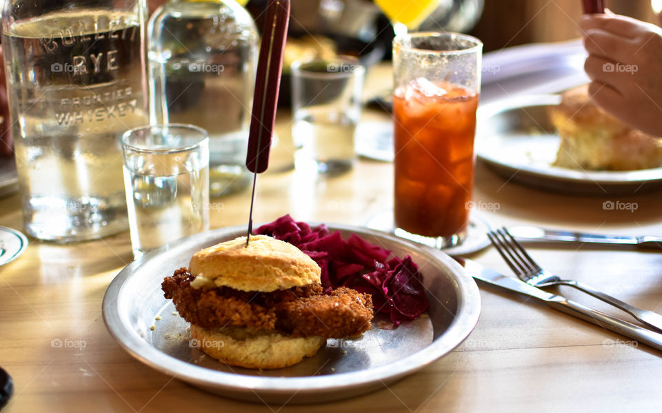 Korean fried chicken sandwich on a biscuit with pickled veggies and a Bloody Mary to wash it down!