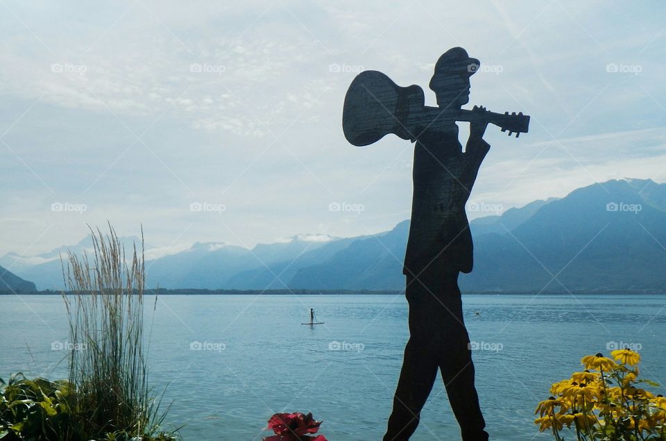 A silhouette of a guitar man sculpture