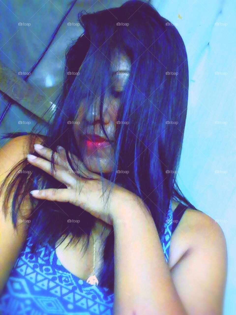 Shying selfi covering with black hairs red lips and face