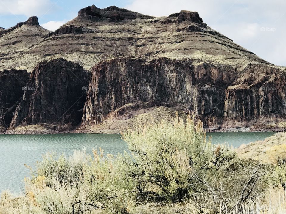 Ancient lava flows by the lake in the arid mountains