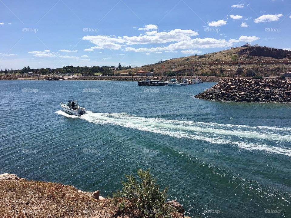 Speedboat returning to harbour marina 