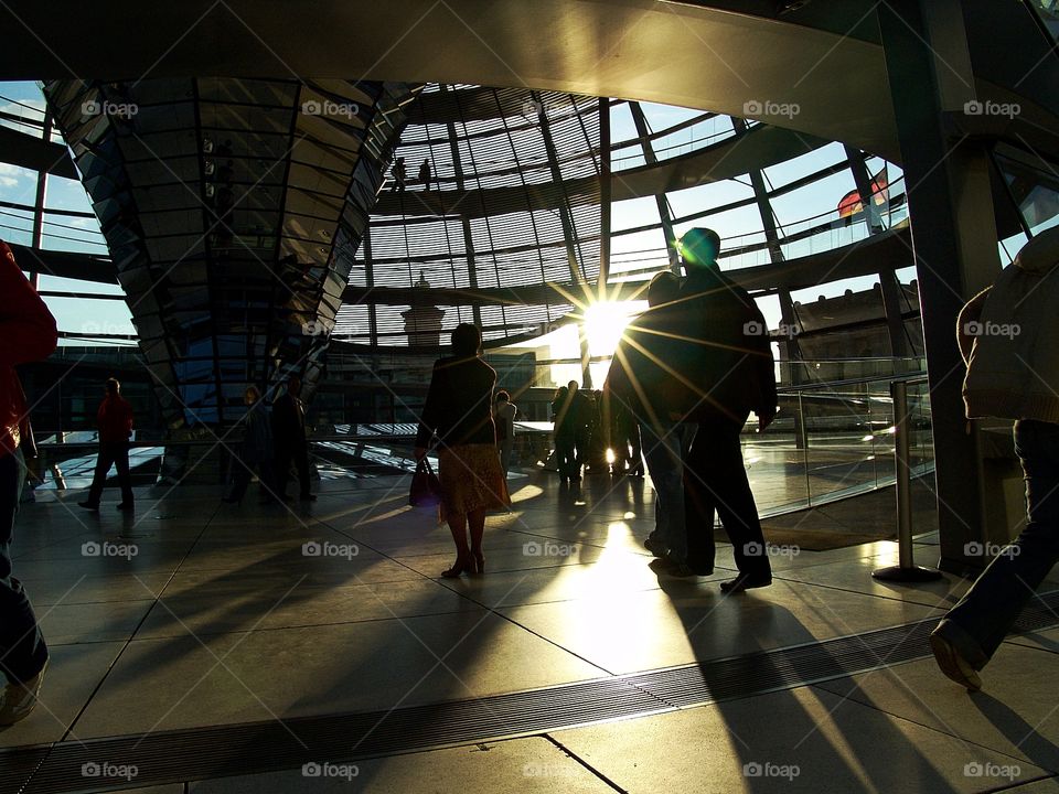 under the dome. visitors of reichstag in the sun