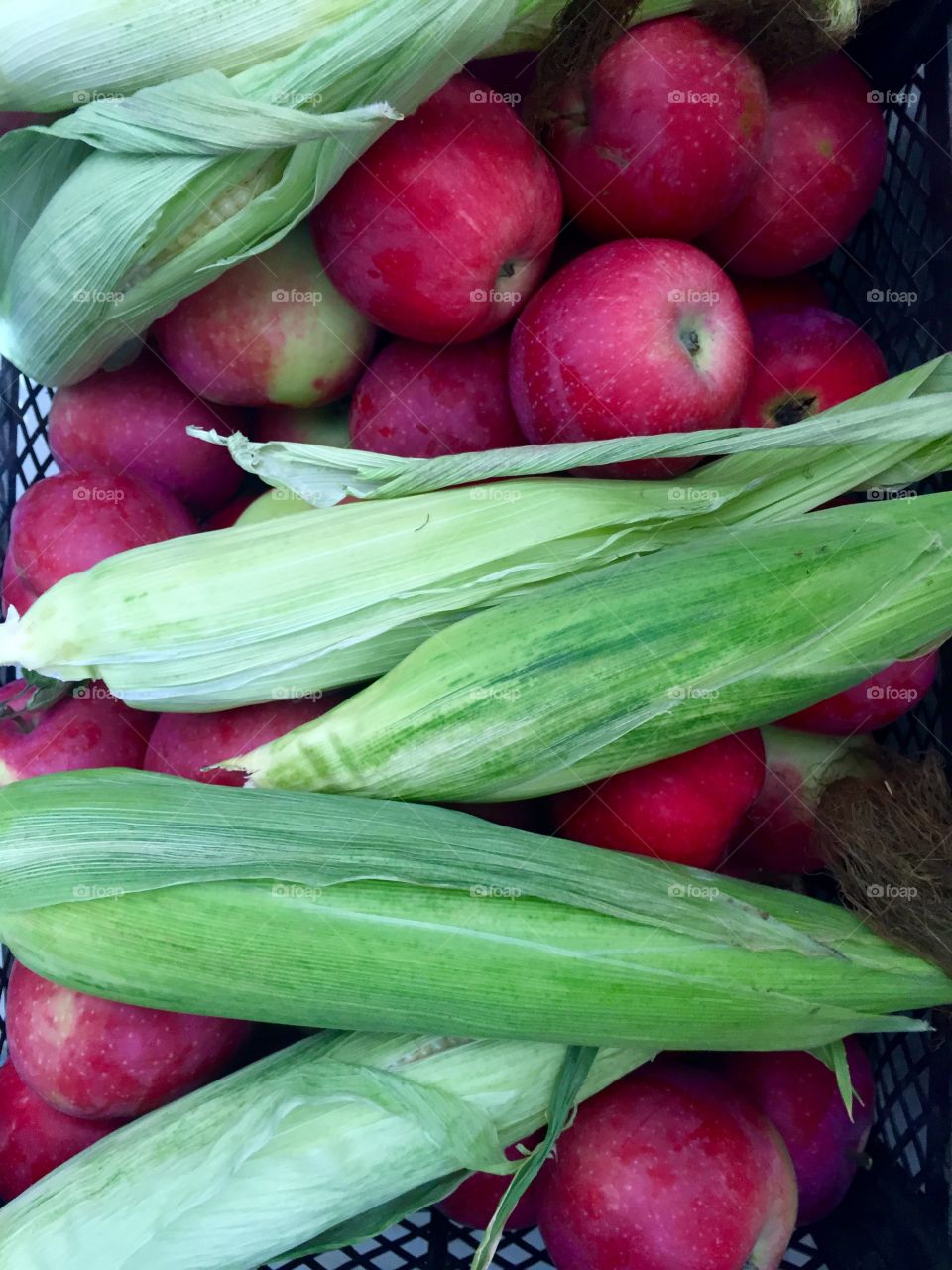 Apples and corns in a basket